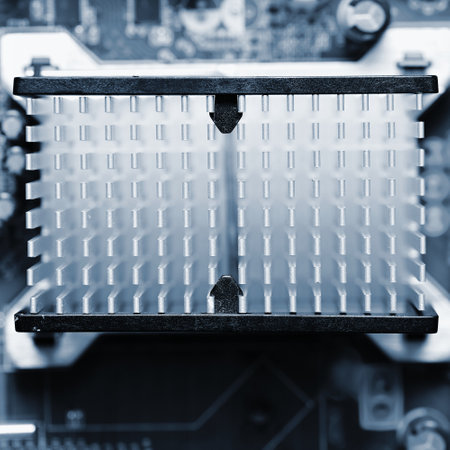 Computer motherboard with heat sink. Printed Circuit Board. Background concept for electrical...