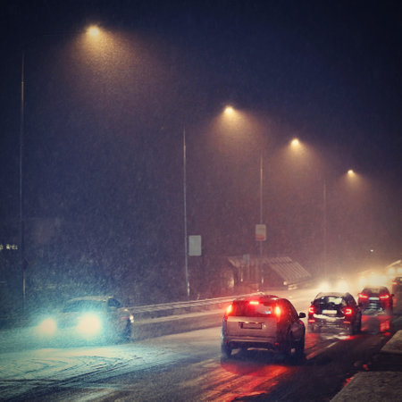 Dangerous winter season with snow on the road. The interior of the car from the driver's point of view - dangerous evening traffic in bad weather.の写真素材