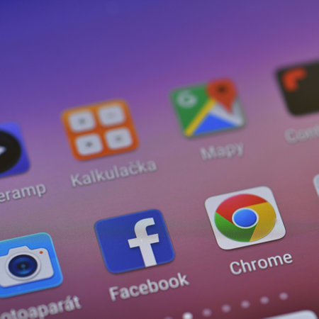 Close-up shot of Facebook application icon on smartphone screen. Facebook is an American social networking service.のeditorial素材