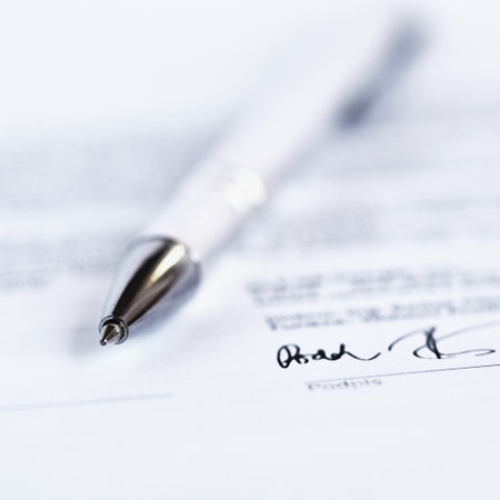 Close up of pen on a contract. Shallow depth of field.の写真素材