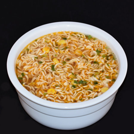 Instant noodles in a bowl on a black background, close-upの写真素材