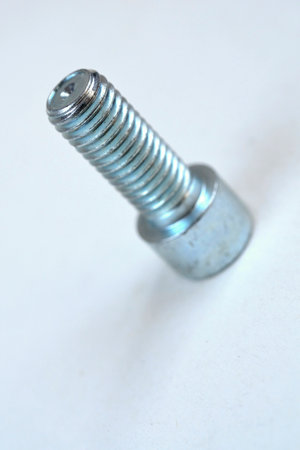 Close-up of a bolt on a white background. Macro.