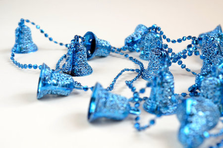 blue christmas bells on a white background, closeup of photo