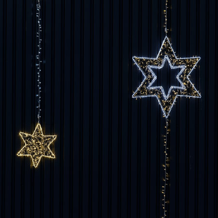 Christmas decorations on a dark background. Shining lights of stars. Abstract colorful background...