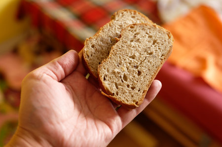 Sliced bread in a woman's hand. Selective focus.