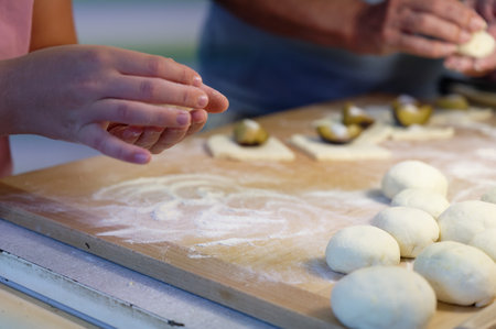 Close-up of female hands kneading dough for bunsの写真素材
