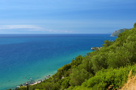Beautiful beach with sea, sun and blue sky. Concept for travel and summer vacation. Greece-island of Corfu. Agios Gordiosの写真素材
