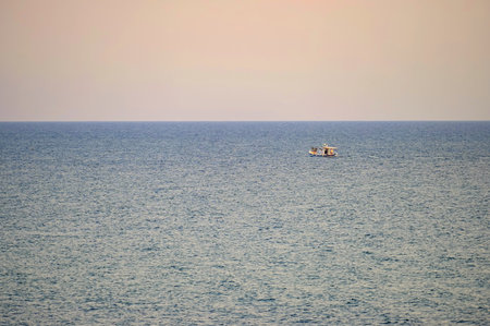 Small fishing boat sailing in an open Mediterranean sea, close-up.の写真素材