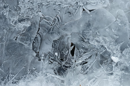 Frozen stream and ice closeup photo. Beautiful winter abstract background in nature. Concept for...