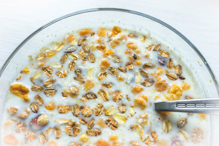 Tasty breakfast with cereals and berries under milk