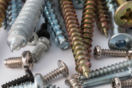 various screws and bolts close-up on a white backgroundの写真素材