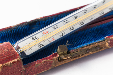Mercury thermometer in old box on white backgroundの写真素材
