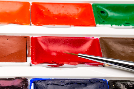 Set of water colors with brush in plastic boxの写真素材