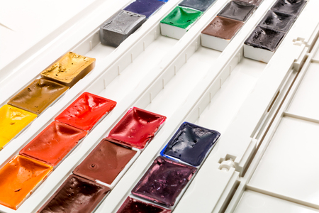 Set of water colors with brush in plastic boxの写真素材