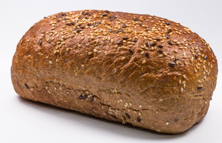fresh baked bread with seeds on white background