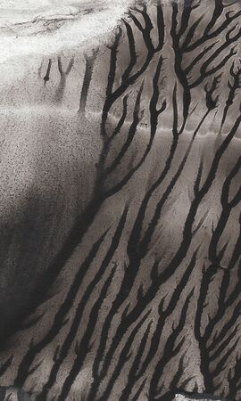 Abstract background with pattern of repeating black and grey shapesの写真素材