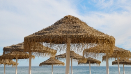 Straw umbrellas on Marbella beachの写真素材