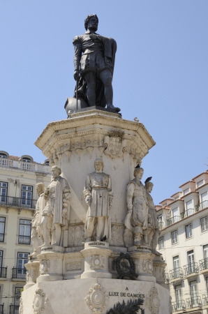 Monumental statue of 16th century epic poet Camoes standing on a pedestal with other smaller statues of classical Portuguese authors の写真素材