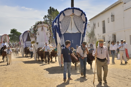 Traditional carts of the brotherhood of Triana in pilgrimage route of El Rocio in the countryside of Huelva that go to the Huelva village of El Rocio. The Pilgrimage of El Rocio is very famous religion event in Spain that meets lots of devout people for dのeditorial素材