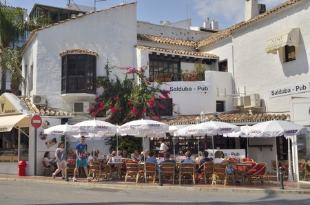 People sitting in a bar of Puerto Banus, a marina located in Marbella, Spainのeditorial素材