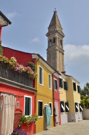 Bell tower and colored houses in Burano, an island of Venice, Italyの写真素材