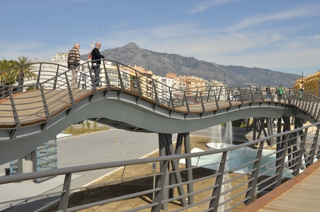 People walking over a bridge in the boulevard  en San Peter of Alcantara, a district of  the city Marbella  in Andalusia, Southern Spain.のeditorial素材