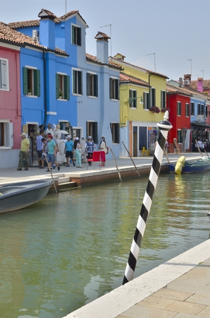 Some people walking along a small canal in Murano, an island in the Venetian Lagoon, northern Italy.のeditorial素材