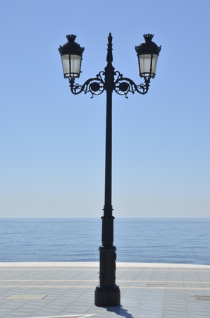 Lamppost in the promenade beach along the Mediterranean sea in Marbella, Andalusia, Spainの写真素材