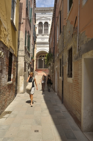 Some people walking by a street in the district of Dorsoduro, Venice, Italy.のeditorial素材