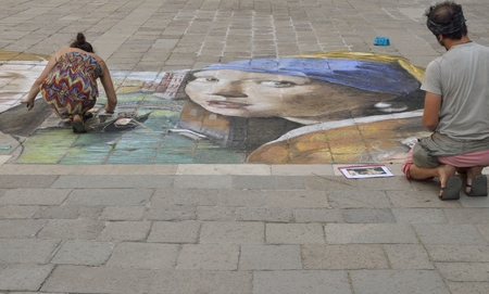 Young street artists drawing on the floor in a square of the district of Santo Polo, in Venice, Italyのeditorial素材