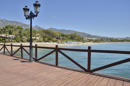 View of the beach from a wooden pier in Marbella, Andalusia, Spainのeditorial素材