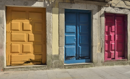 Colorful wooden doors on ruined building  in the historical city of Porto, Portugal.の写真素材