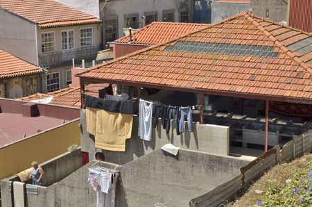 Woman at a washing place in the historic part of Porto, Portugalのeditorial素材