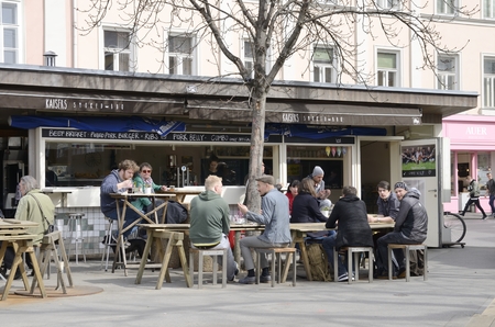 People at a bar stall on market in square of Graz,  the capital of federal state of Styria, Austria.のeditorial素材