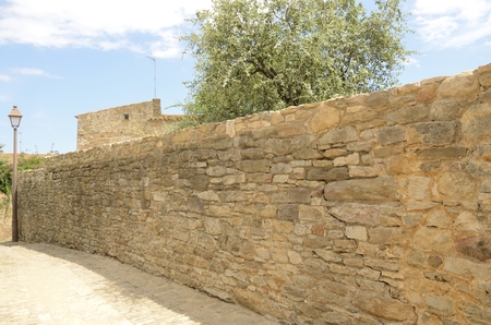 Path next to stone wall in the medieval village of Peratallada, located in the middle of the Emporda...