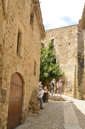 People at a narrow alley of  the medieval village of Pals, located in the middle of the Emporda region of Girona, Catalonia, Spain.のeditorial素材