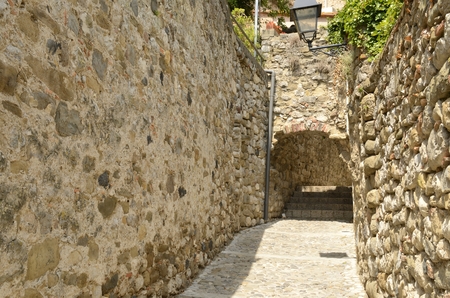 Stone arch in alley of  Besalu,  a  medieval town of Girona, Catalonia, Spain.の写真素材