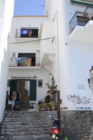 Independence flags on building in alley in Cadaques, Girona, Catalonia, Spain.のeditorial素材
