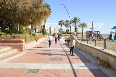 People walking in the promenade of Estepona, Malaga, Andalusia, Spain.のeditorial素材