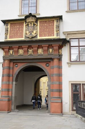 People passing by the Swiss Gate of Renaissance at exterior of the Hofburg Palace in Vienna,...