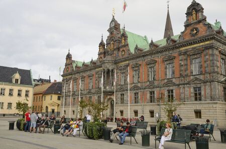 Malmo, Sweden - September 17, 2018: People at benches in front of the historical town hall at the...