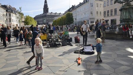 Copenhagen, Denmark - September 15, 2018:  Guitarist  and kids playing at  the animated Amager Square in central Copenhagen, Denmark.のeditorial素材