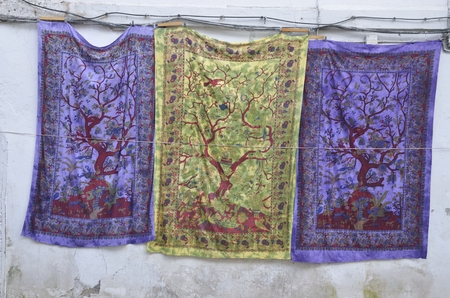 Silk fabrics on white wall in the district of Albaicin, Granada, Andalusia, Spain.の写真素材