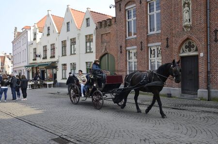 Brugge, Belgium - March 31, 2019: Horse carriage by the old town of  Brugge, Belgium.のeditorial素材