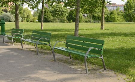Green benches in park of Pamplona, Navarre, Spain.