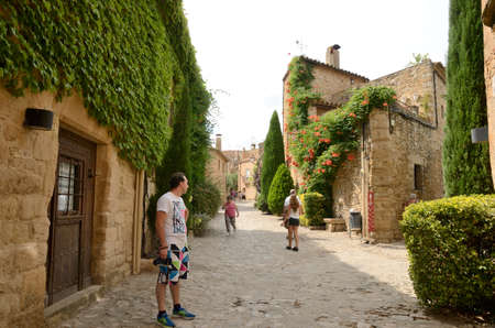 Peratallada, Spain - July 25, 2017: People at cobbled street of the medieval village of Peratallada, located in the middle of the Emporda region of Girona, Catalonia, Spain.のeditorial素材