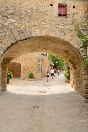 Peratallada, Spain - July 25, 2017: People by cobbled street of the medieval village of Peratallada,...