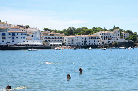 Cadaques, Spain - July 27, 2017: Few people bathing at sea at beach on a summer day in Cadaques, a mediterranean town in the province of Girona, Catalonia, Spain.のeditorial素材
