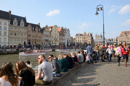 Ghent, Belgium - March 31, 2019: People at the banks of the canal in the Old Town of Ghent, the capital of the East Flanders province in Belgium.のeditorial素材