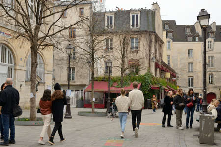 Paris, France - March 4, 2022: People in pedestrian cobbled street in the fourth district of Paris, France.のeditorial素材